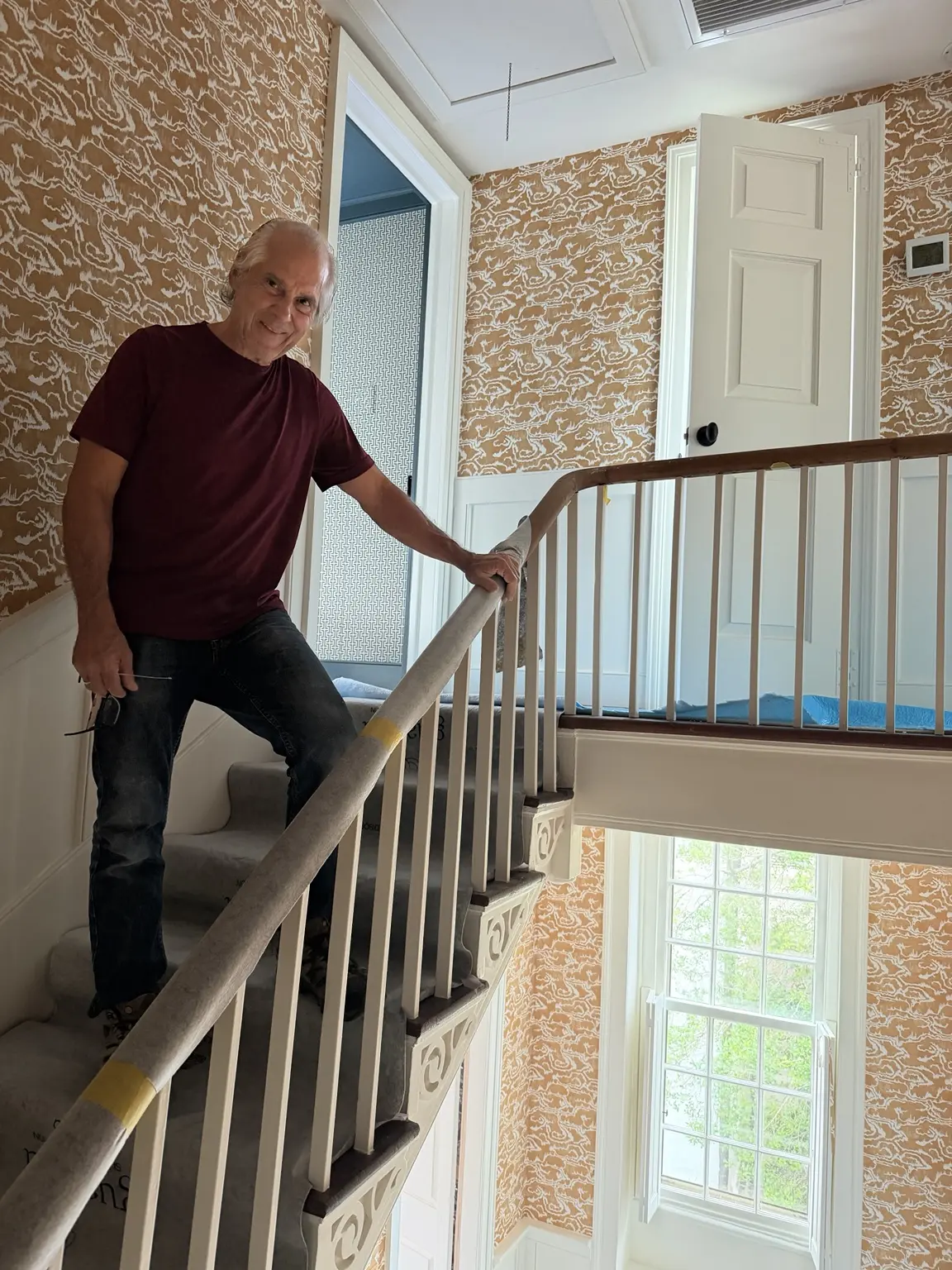 Charleston wallpaper craftsman completing a three-story stairway installation at 45 Tradd Street