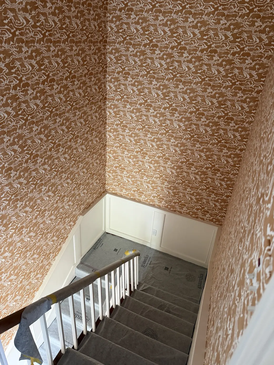 Three levels of matched wallpaper above white wainscoting in a historic Charleston home