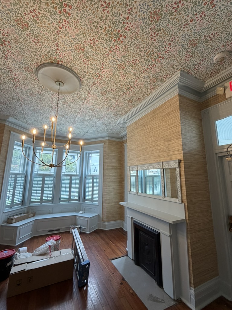 Finished Tri Delta chapter house room with natural grasscloth walls and floral ceiling wallpaper in Charleston